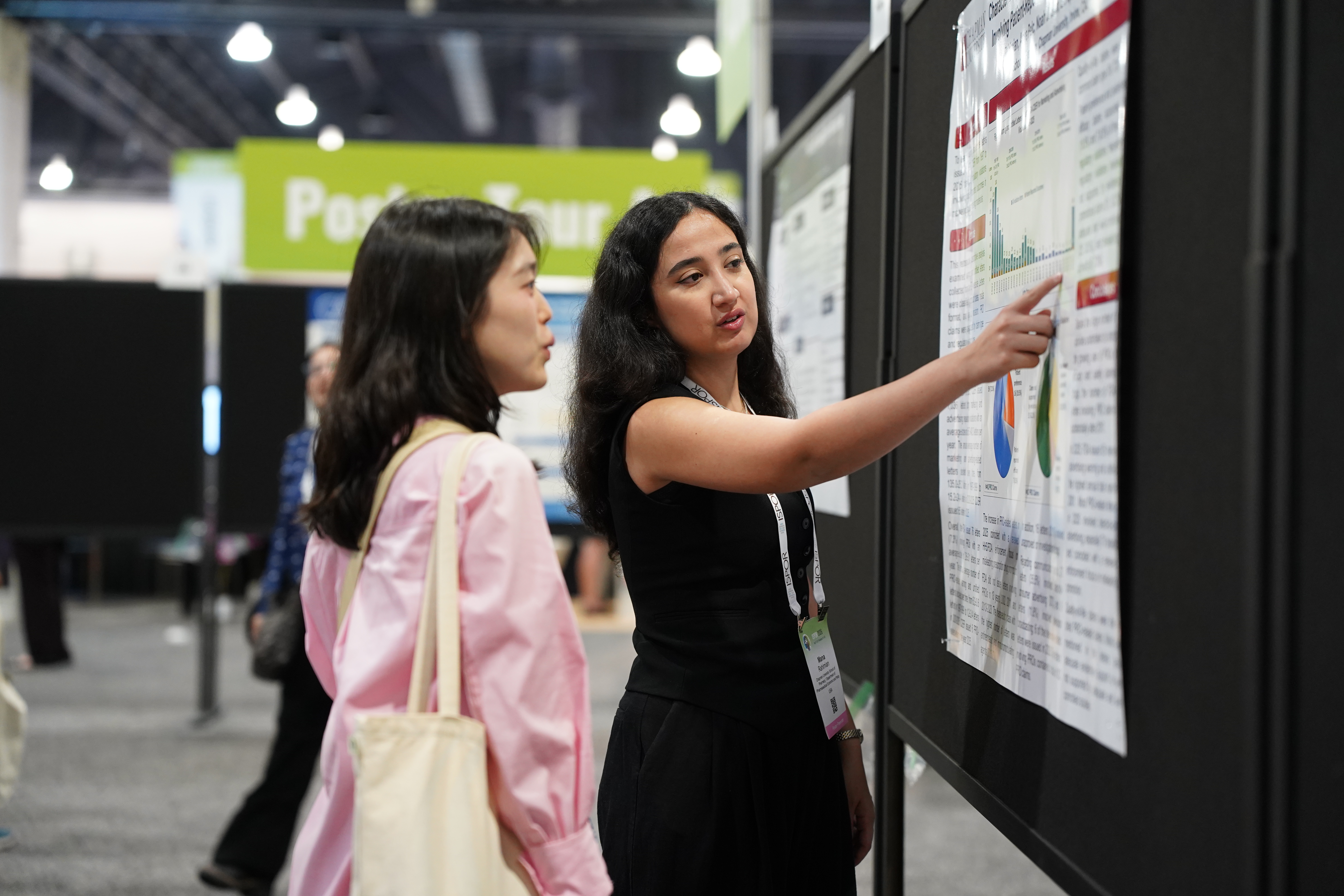 Two Attendees Viewing a Poster