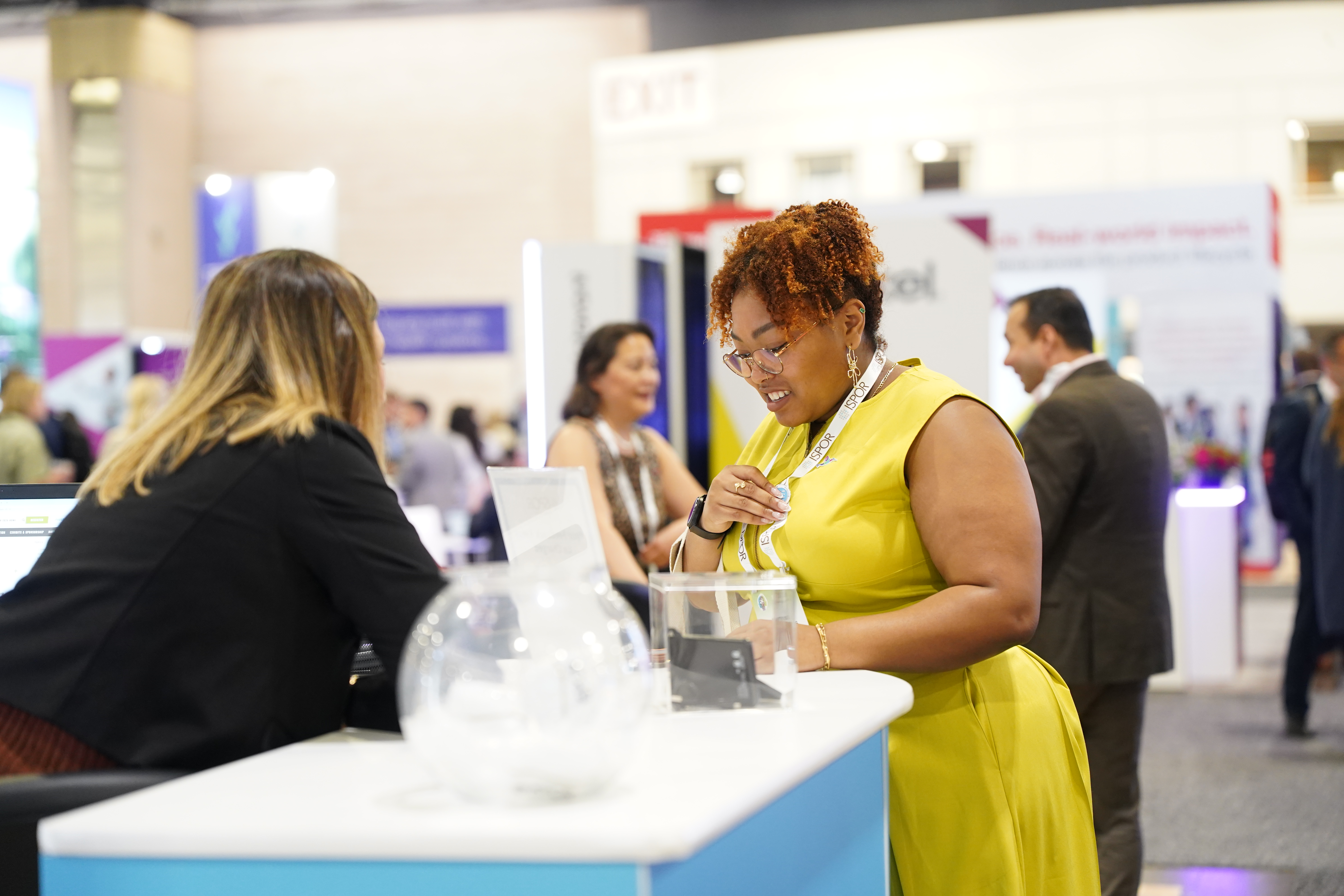 Conference attendee at a booth in the ISPOR 2026 exhibit hall